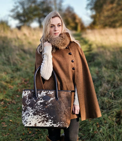 Bethany wears her tweed cape with a bethany rae cowhide bag